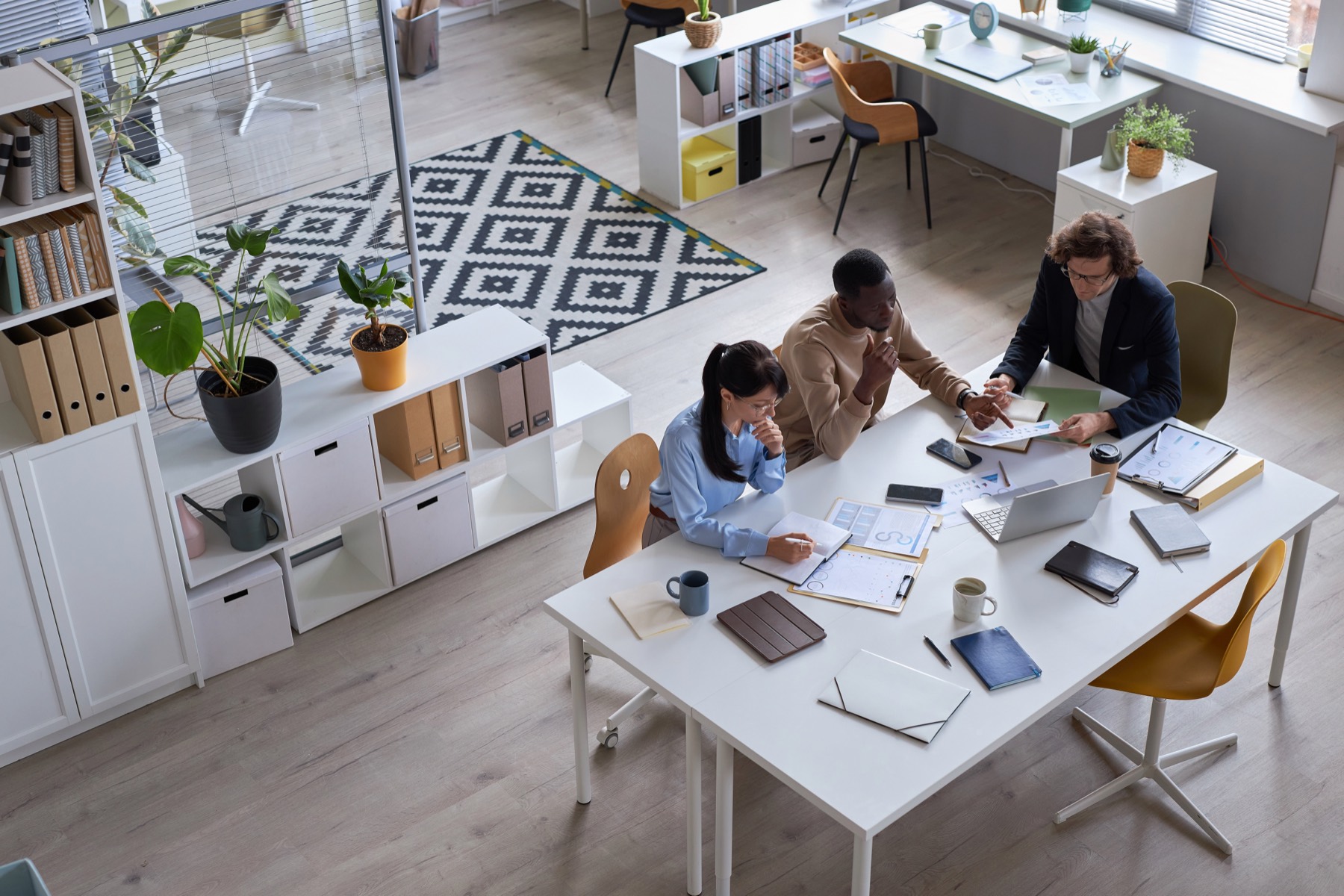 Three people collaborating at a desk